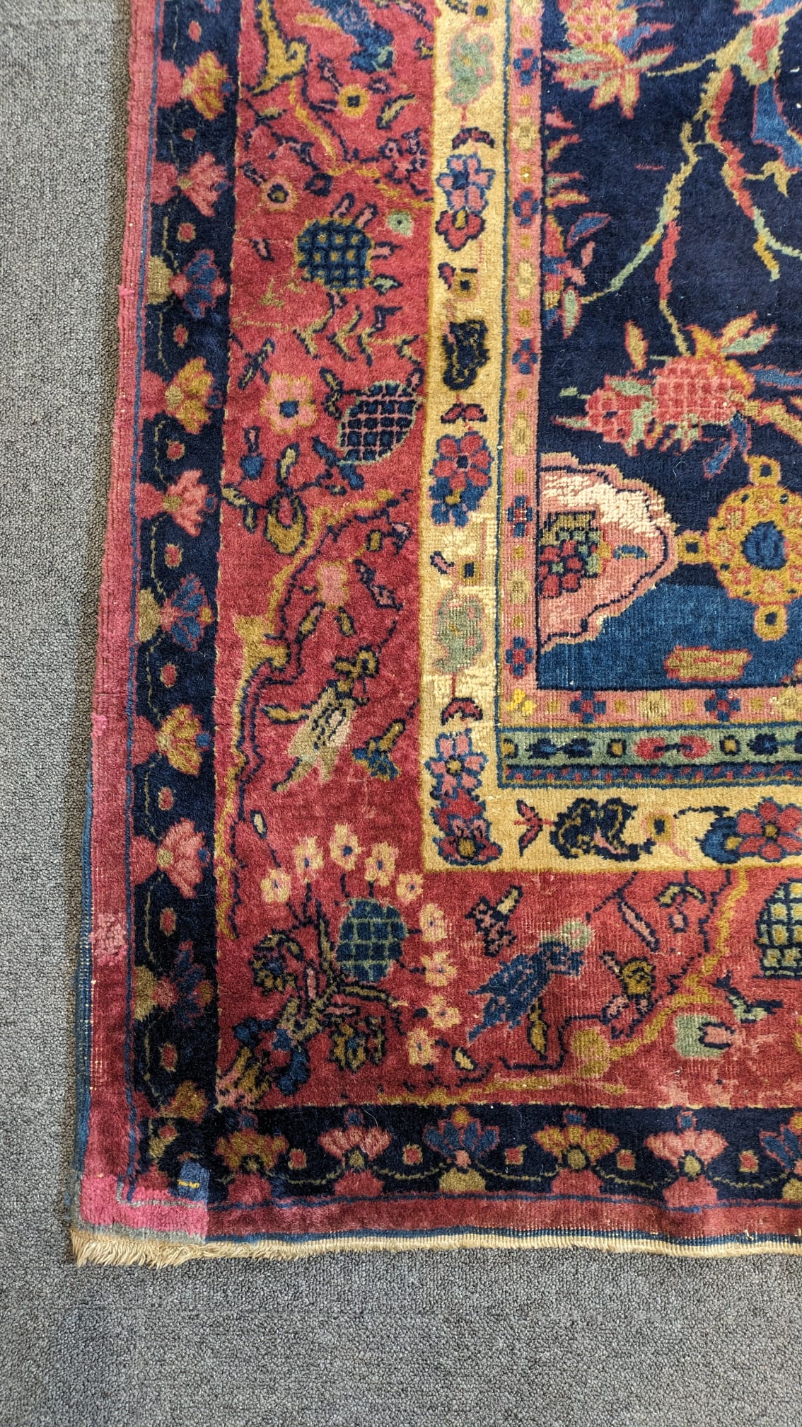 A Khorasan Mashhad red ground carpet, circa 1930’s, with field of stylised floral motif medallions, multi-bordered, 545 x 400cm. Condition - fair